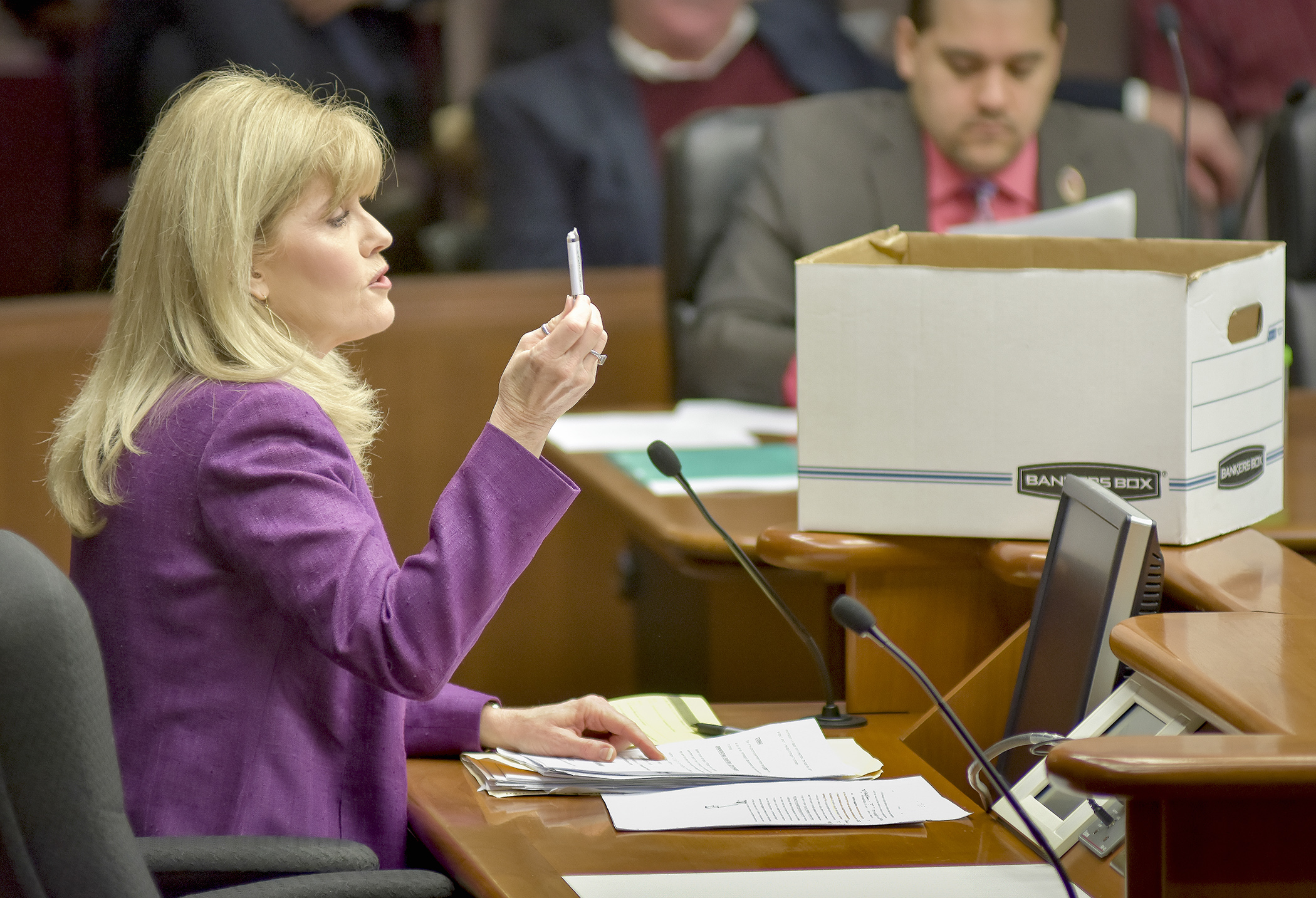 Rep. Peggy Scott displays a thumb drive and a banker’s box to illustrate methods of record storage during her Feb. 28 presentation to the House Civil Law and Data Practices Policy Committee. Photo by Andrew VonBank